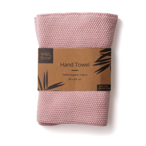 Knitted cotton hand towel in Rose pink shown in kraft paper packaging