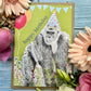 Eco birthday card, lime background with a large gorilla in a party hat and the words "happy birthday"