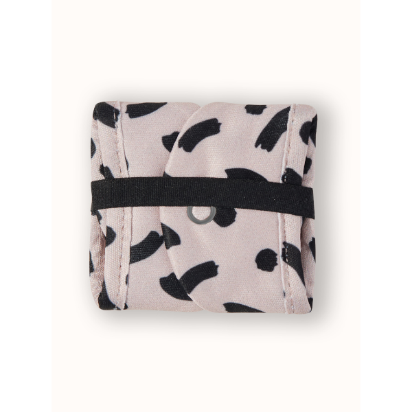 Reusable period pad in Latte design (beige background with black pattern ), liner, folded into itself and secured with elastic tab