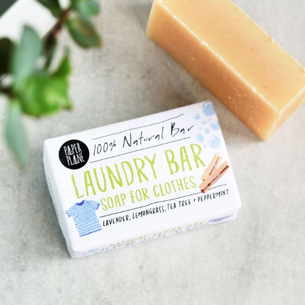 Paper Plane laundry soap bar shown wrapped and unwrapped