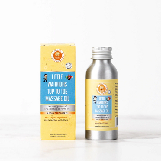 Little Warriors top to toe massage oil in aluminium tin next to cardboard packaging