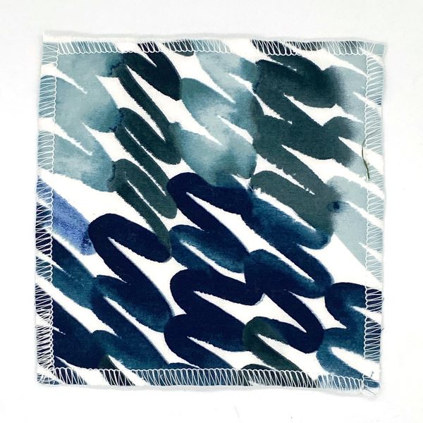 Reusable make up pad in Teal swirl design  (white background with different shades of teal and blue swirling)