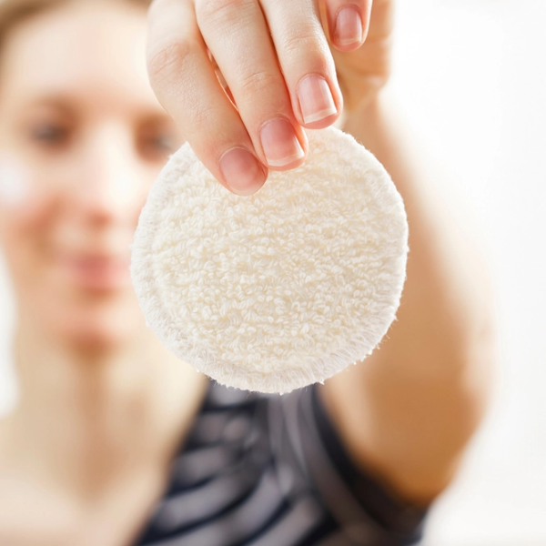 Organic cotton makeup round being held in a hand