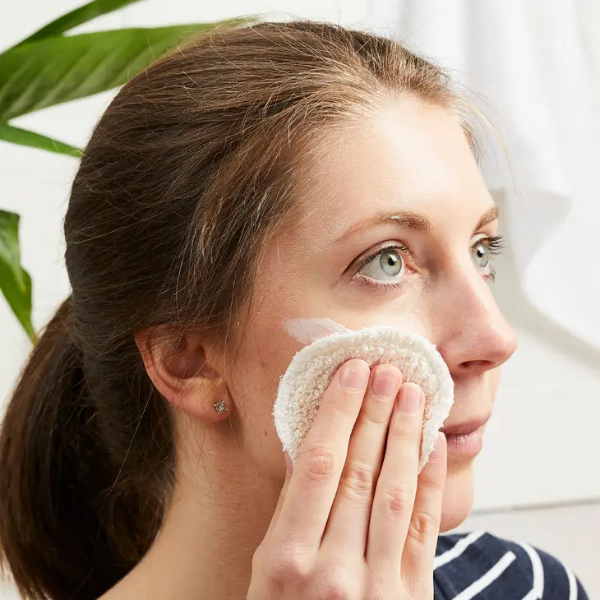 Organic cotton makeup round in use on a face