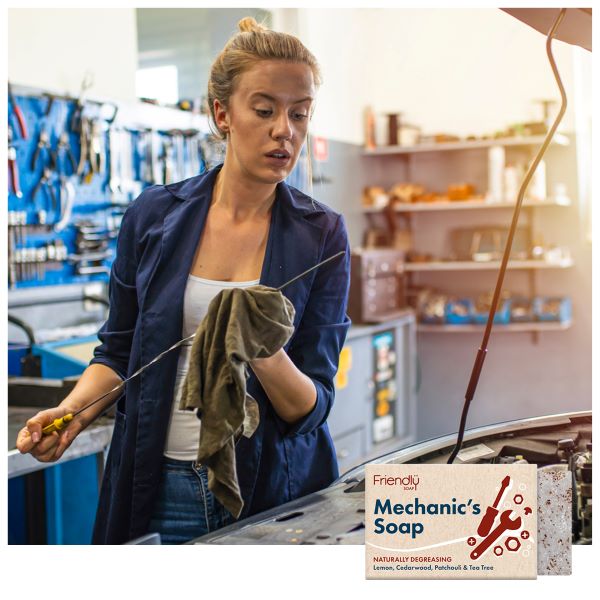 A mechanic shown wiping a cloth along a metal oil check pole alongside an image of the soap bar inset