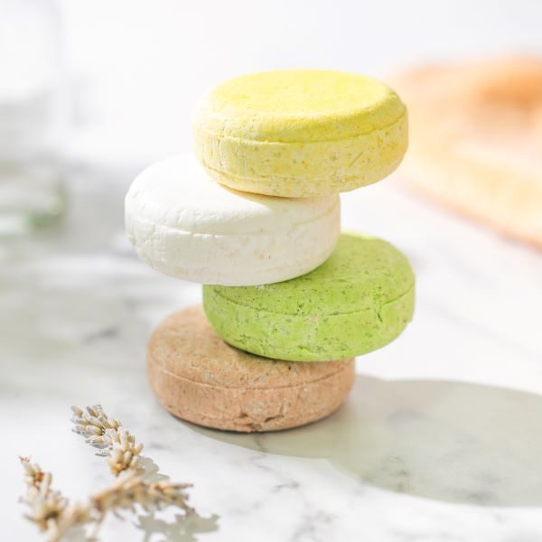 Cleansing shampoo bar range unwrapped and stacked one on top of each other