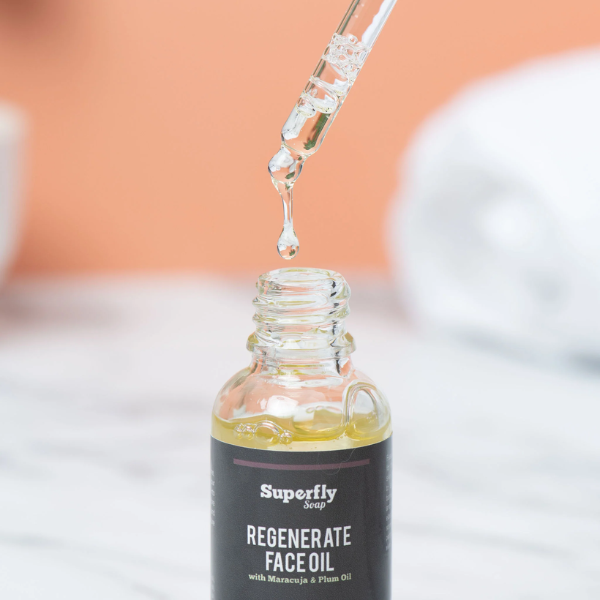 Superfly Soap regenerate face oil with pipette dripping product into glass bottle
