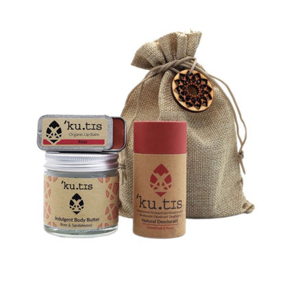 Eco-friendly natural skincare gift pouch shown with the products alongside - a natural deodorant in paper tube, lip balm in metal tin and uplifting body butter in glass jar (rose fragrances)