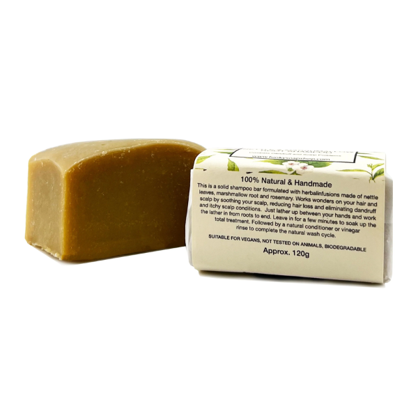 Shampoo bar shown wrapped and unwrapped with paper label reading "100% natural and handmade"