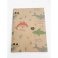 Eco-friendly recyclable wrapping paper in shark design (brown paper with colourful sharks in the sea) shown as single sheet