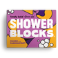 Totally solid shower gel bar in mango and passionfruit, shown in purple and yellow cardboard packaging
