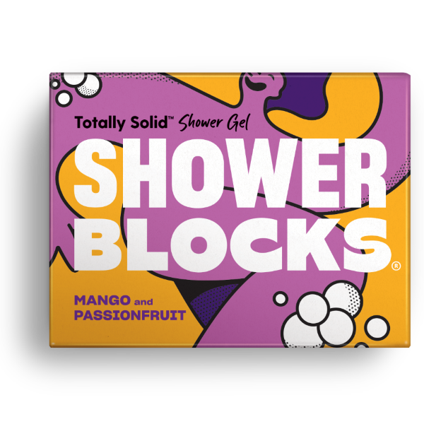 Totally solid shower gel bar in mango and passionfruit, shown in purple and yellow cardboard packaging