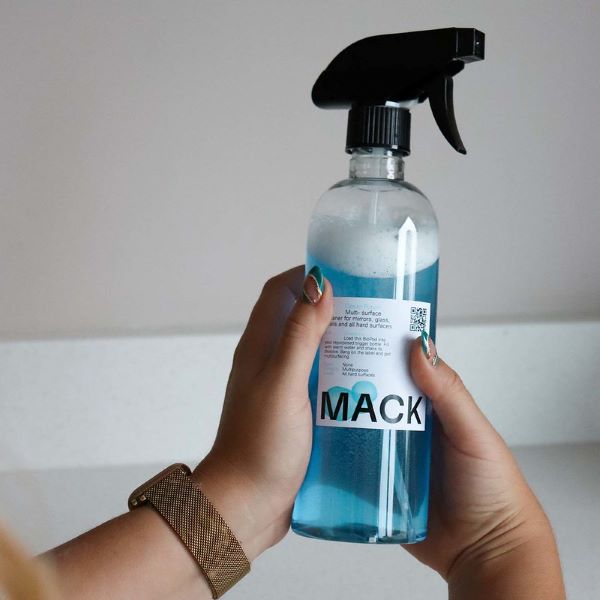 Mack reusable spray bottle with blue liquid inside