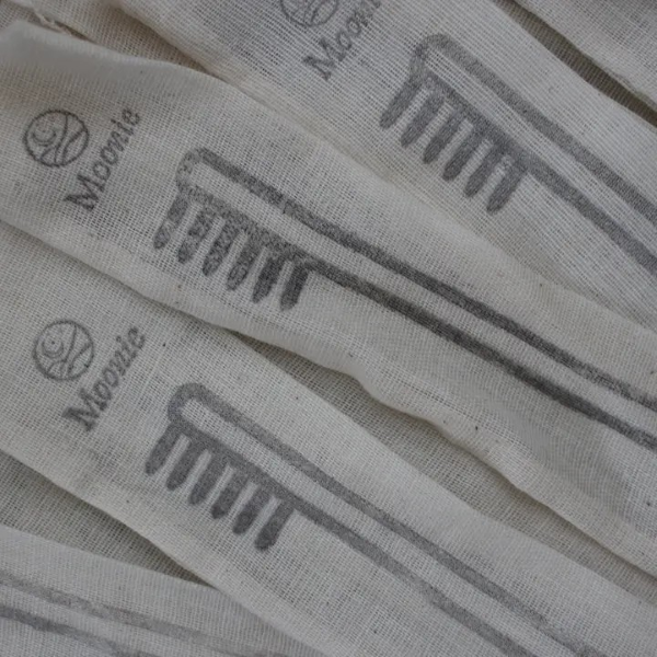 Several upcycled, handmade cotton pouches for bamboo toothbrush