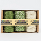 Natural twirly twine trio shown in green/white combination (one solid green, one white and green, and one white) packaged in cardboard box with paper label