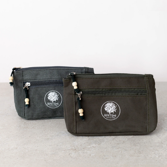 Two upcycled canvas black washbags with Sintra Naturals logo and zip
