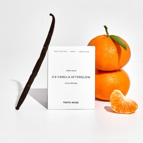 Perfume balm in white cardboard packaging with packaging reading "Captivating/Warm/Impulsive Vanilla Afterglow solid perfume" shown nectarines and vanilla pod