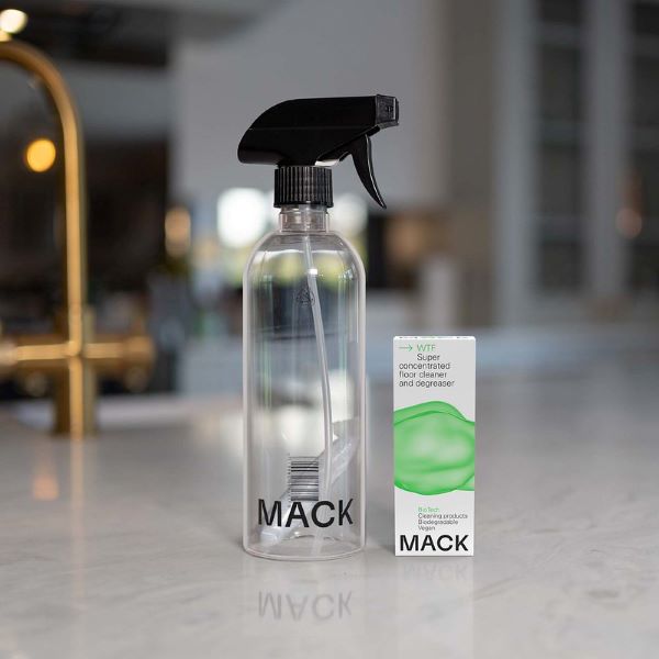 Mack cleaning pod for floors in cardboard box with text "super concentrated floor cleaner and degreaser" alongside reusable spray bottle