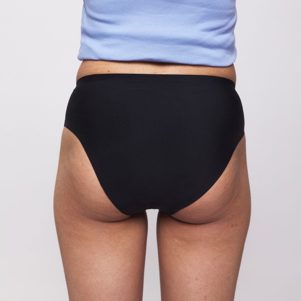 Teen stretch period pants shown on model from the back