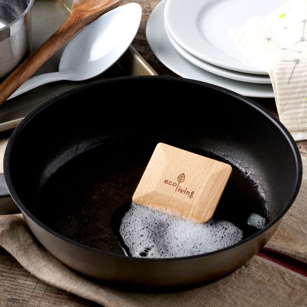 Wooden pot scraper in a pot with some soapy bubbles