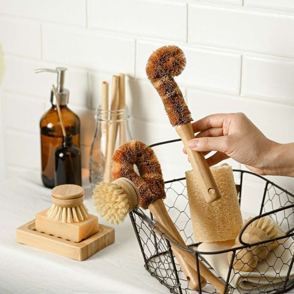 Jungle Culture's set of 6 bamboo and coconut fibre brushes in a wire basket in kitchen
