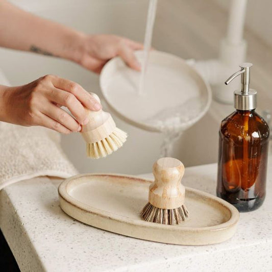 Bamboo pot scourer set shown with one in use on a plate
