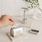 Hand popping a safety razor blade in the storage tin