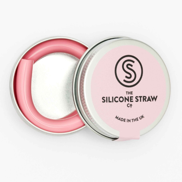 Silicone straw in light pink contained in small round tin shown with lid off and straw inside