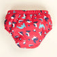 Reusable swim pants back view in Puffling Paddle design (red background with puffins and seals)
