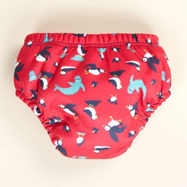 Reusable swim pants back view in Puffling Paddle design (red background with puffins and seals)