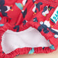 Reusable swim pants side elastic view in Puffling Paddle design (red background with puffins and seals)