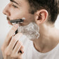 Eco-friendly metal safety razor with stand Black in use on face