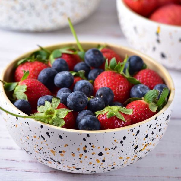 Bamboo serving bowl with berries in white (white with coloured speckles on outside, bamboo inside)
