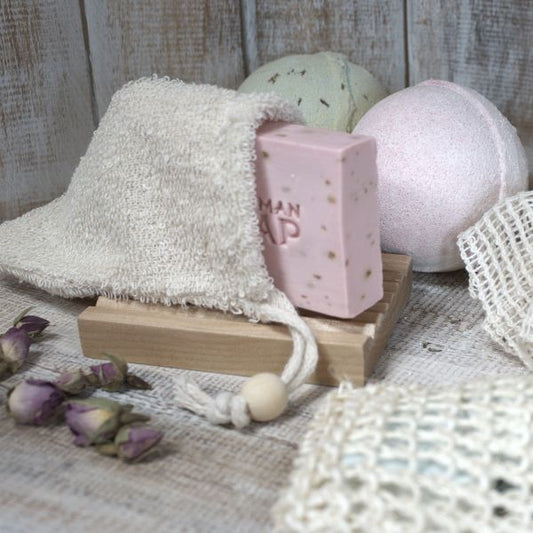 Bamboo soap bag with soap inside on a wooden soapdish