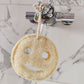 Eco-friendly bath time smile loofah hanging from tap
