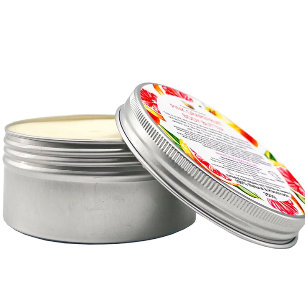 Eco-friendly vegan body butter in aluminium tin, shown open with cream inside, side view. Pink grapefruit.