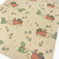 Eco-friendly Christmas wrapping paper Brown with colourful dinosaurs pulling Santa's sleigh
