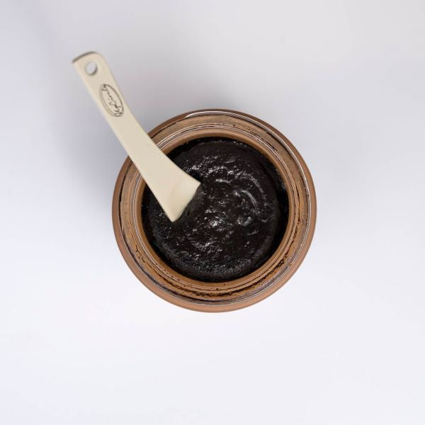 Coffee face scrub open with cosmetic spatula