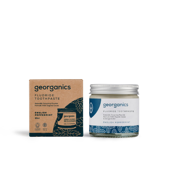 Georganics fluoride toothpaste with English peppermint in glass jar alongside cardboard box