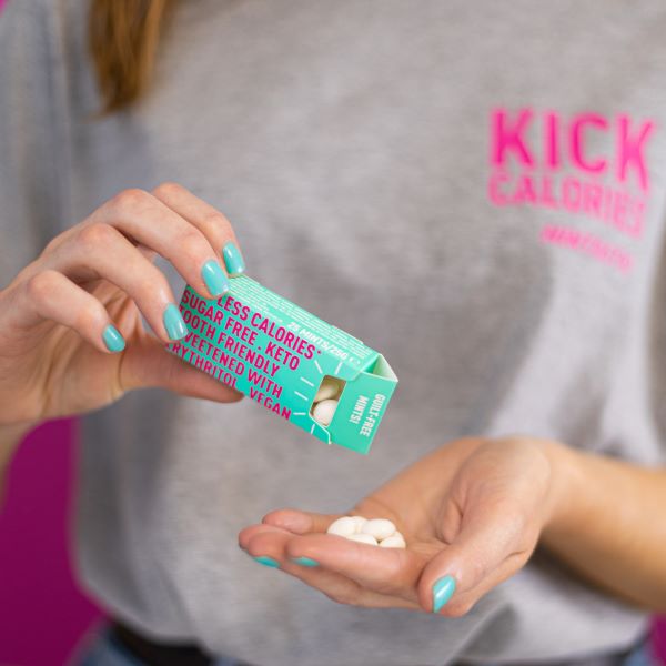 Mintastic sugar-free and vegan mints in a hand removing the mints from plastic-free box