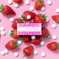 Mintastic sugar-free and vegan mints in strawberry - boxes with some mints scattered alongside some fresh strawberries