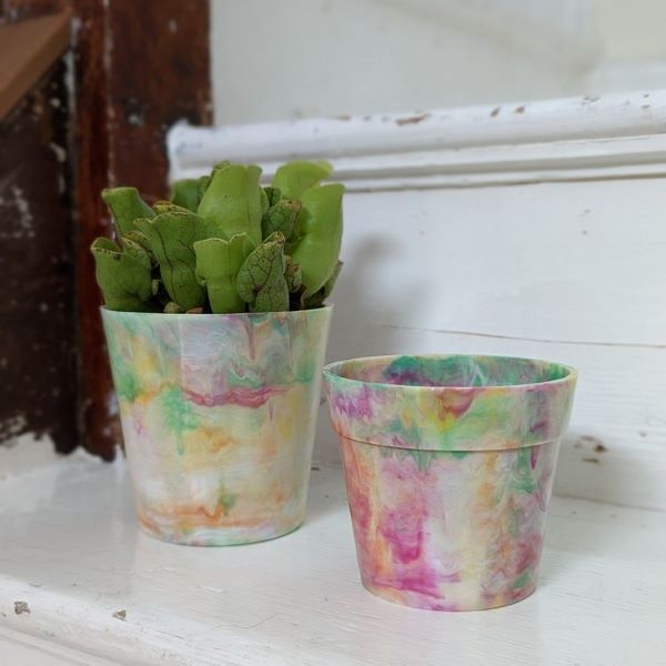 Replic plant pot from recycled plastic in tie die colour - a swirly mixture of pink, yellow, green