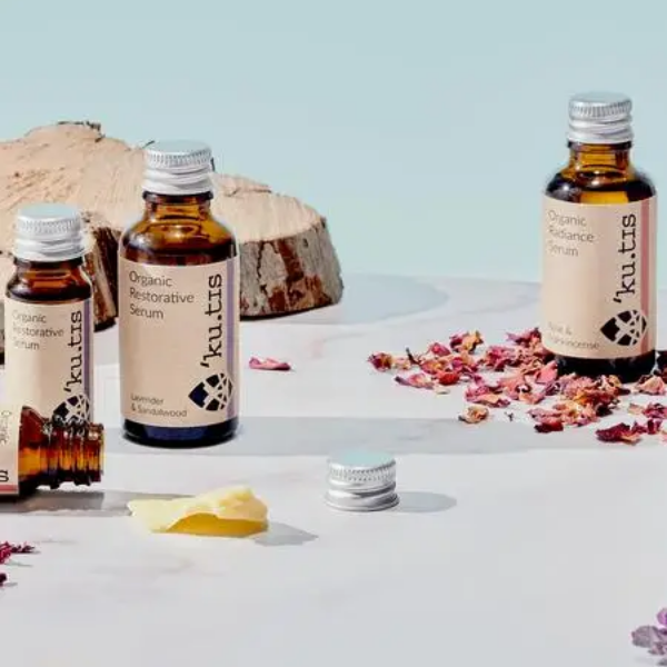 Organic facial serums with dried petals  in glass bottles with aluminium lid