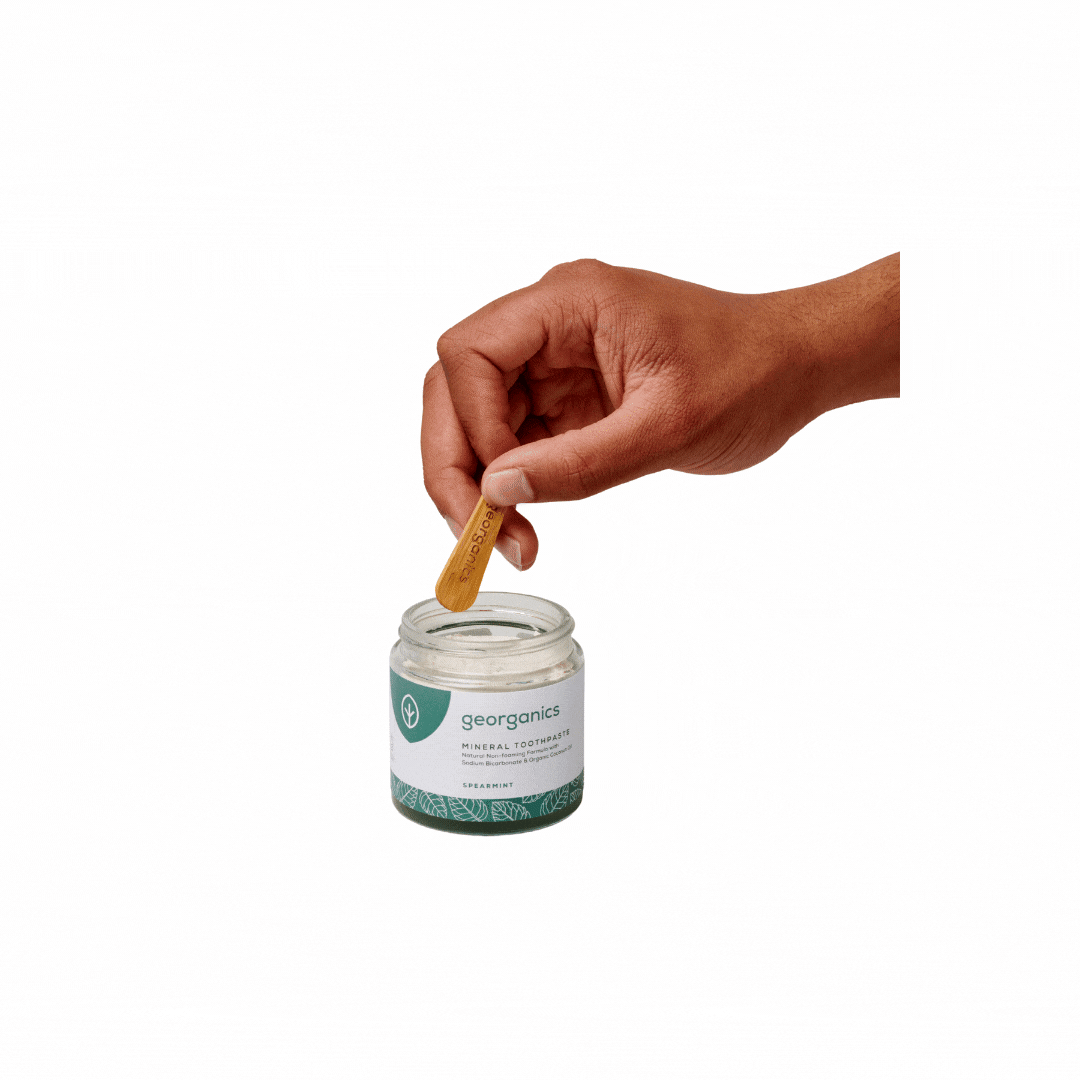 Georganics eco-friendly natural toothpaste being scooped out with bamboo spatula