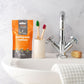 Eco-friendly toothpaste tablets orange with fluoride at sink
