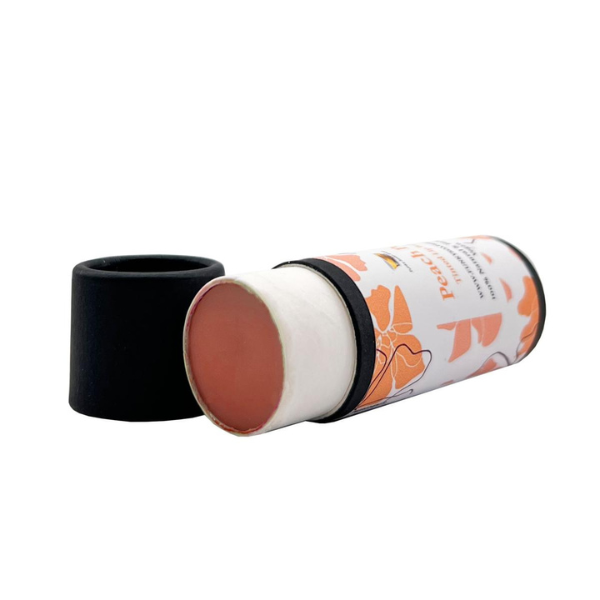 Vegan tinted lip balm Peach pop in biodegradable cardboard tube with lid off