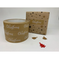 Eco-friendly paper tape Brown with white wording saying Christmas and little white snowflakes, next to wrapped parcel sealed with the tape